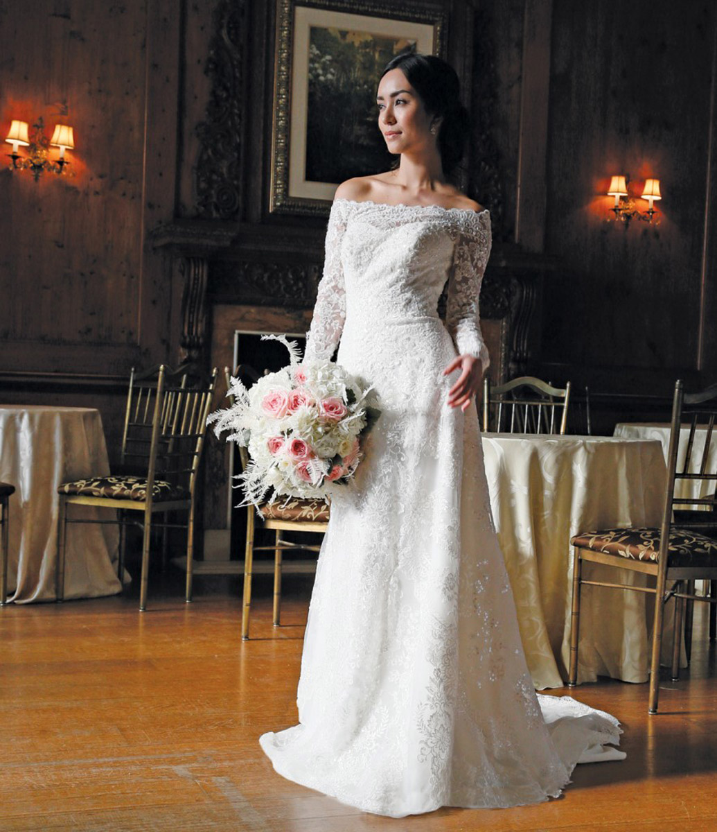 bride in white with flowers in ballroom lace grandiose
