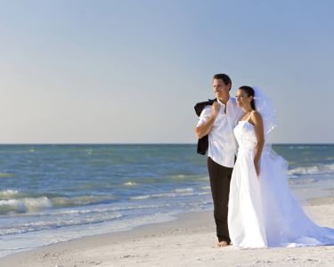 bride-groom-on-beach-looking-out-to-ocean