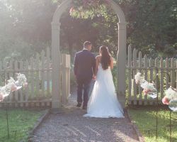 029-bride-groom-walking-through-wedding-garden