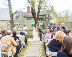 inn-ceremony-outdoor-arch-wedding-bride-groom-kiss
